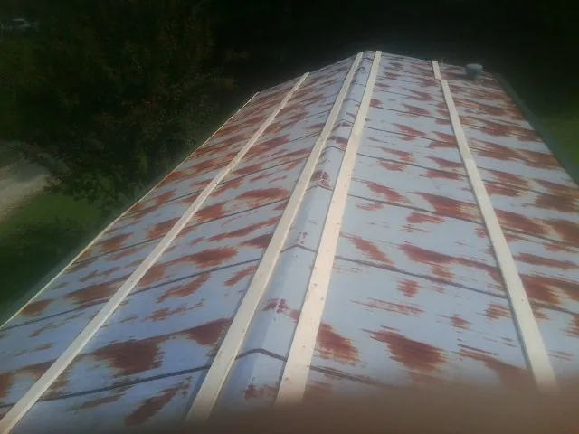 Rusted metal roof panels with new wood purlins before replacement — Storm Damage Roof Repair in Mount Juliet by Roofing Brothers